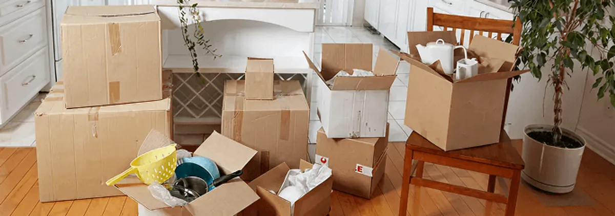 Packed moving boxes and household items in a kitchen before move-out or move-in cleaning, Staten Island, NY.